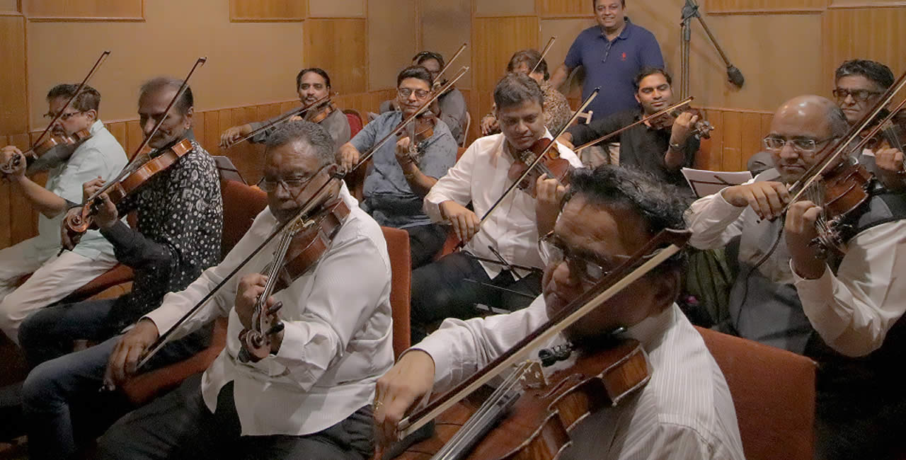 Anand Nithoo with Violin section.