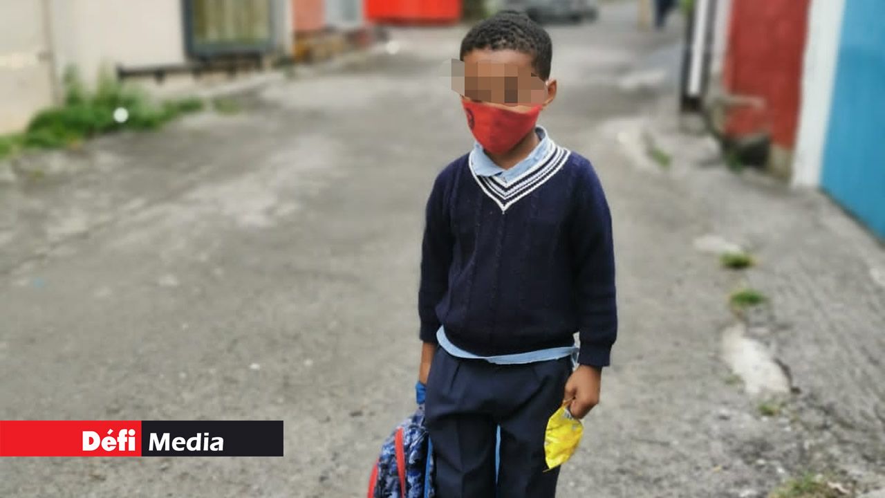 Malgré son jeune âge, ce petit garçon tient à respecter le port du masque.