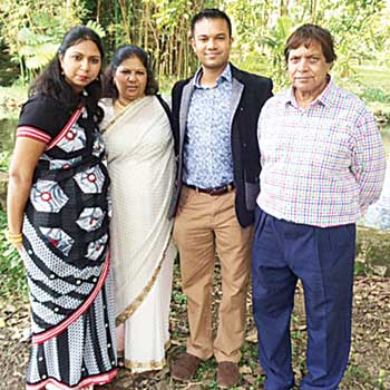 With his parents and sister.